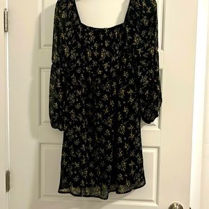 Black empire waist dress with gold flowers.